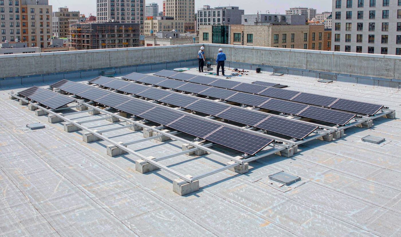 Commercial BESS cost: solar array installation on a flat commercial roof