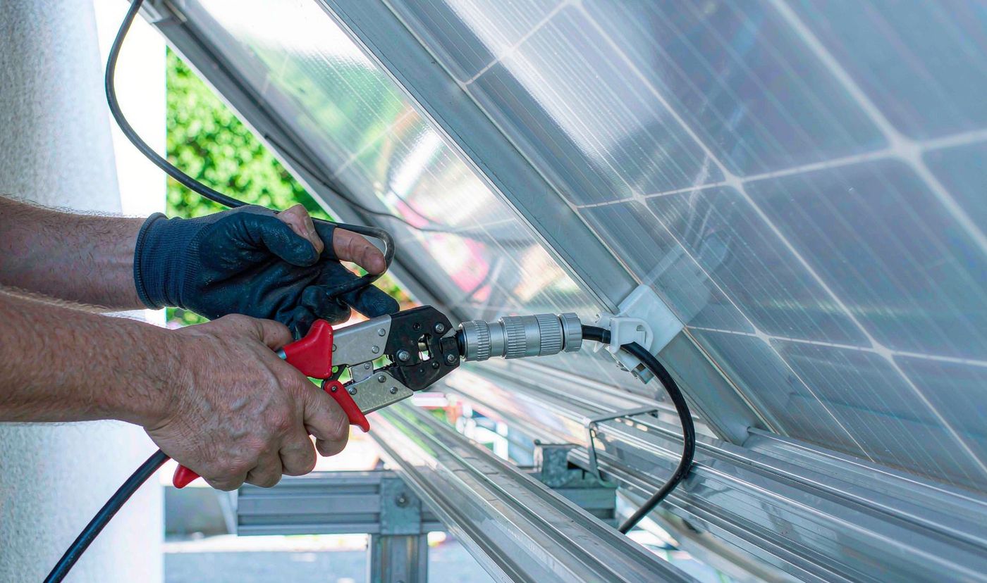 100kW solar Philippines: MC4 connector crimping during rooftop installation