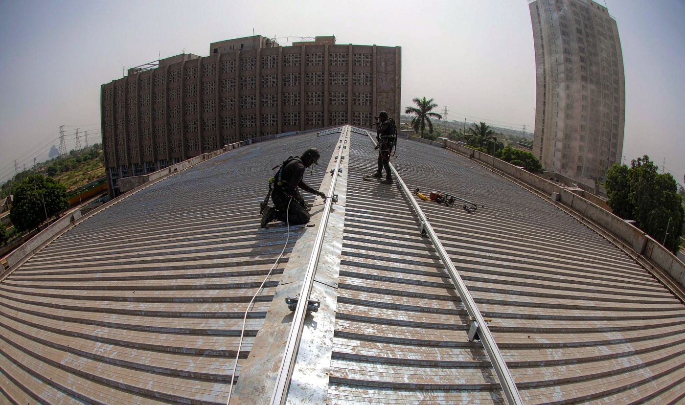 250kW solar Ghana: mounting rail installation on a hotel metal roof